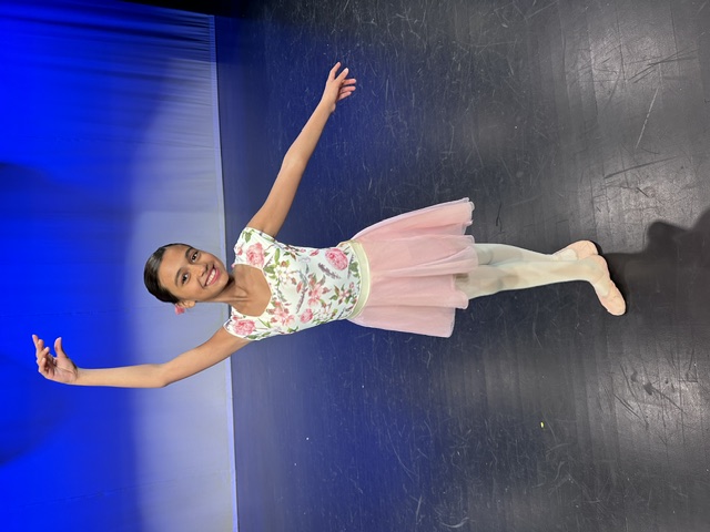 A Young Ballet Student Posing On Stage